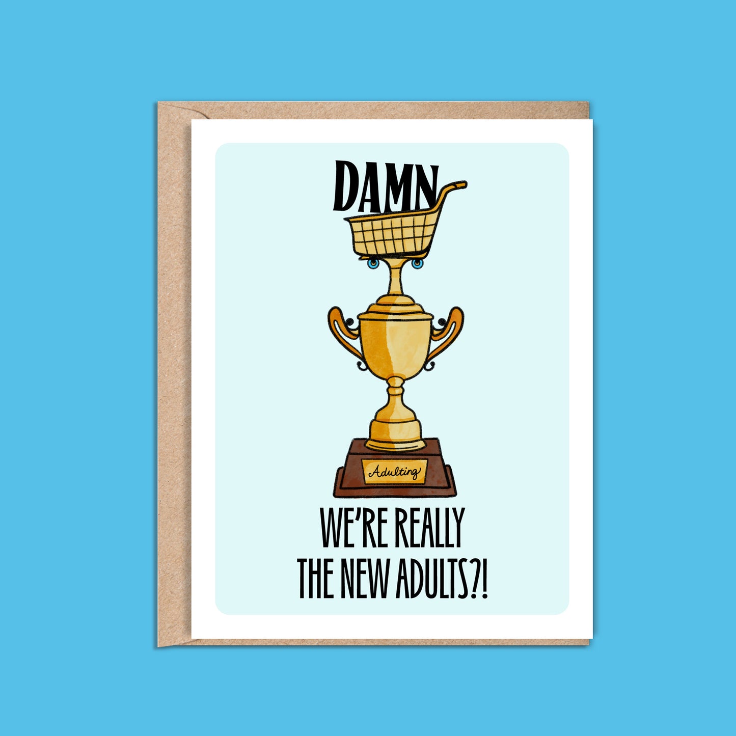 4.25 x 5.5” A2 size card illustration of gold grocery shopping cart trophy, light blue background. The text reads, "Damn We’re Really the New Adults". Blank inside. Black Woman Owned.