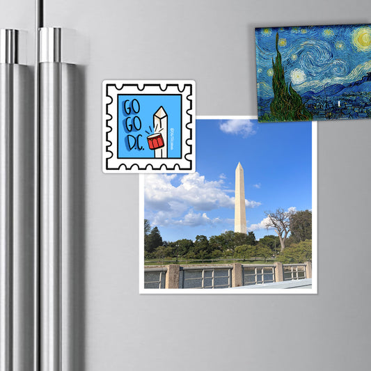 Vibrant postage stamp magnet inspired by Washington DC's Go Go music culture, featuring red drums and the Washington Monument on a light blue background. Includes the words 'Go Go DC'. Ideal for your office, kitchen, and more!