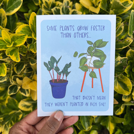 4.25 x 5.5” A2 size card colorful illustration of a ZZ plant and pothos plant with a light blue background. The encouragement card reads ‘Some plants grow faster than others…that doesn’t mean they weren’t planted in rich soil!’. Envelope included. Black Woman Owned.