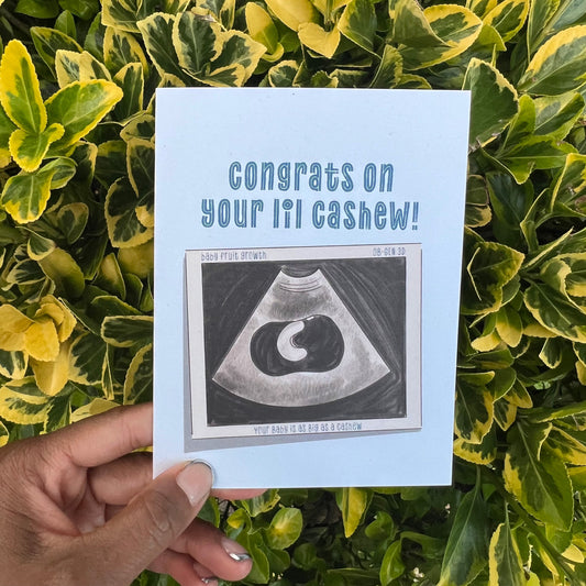 4.25 x 5.5” A2 size card illustration of a baby sonogram with a baby the size of a cashew. The card reads ‘Congrats on your lil cashew!’. Envelope included. Black Woman Owned.