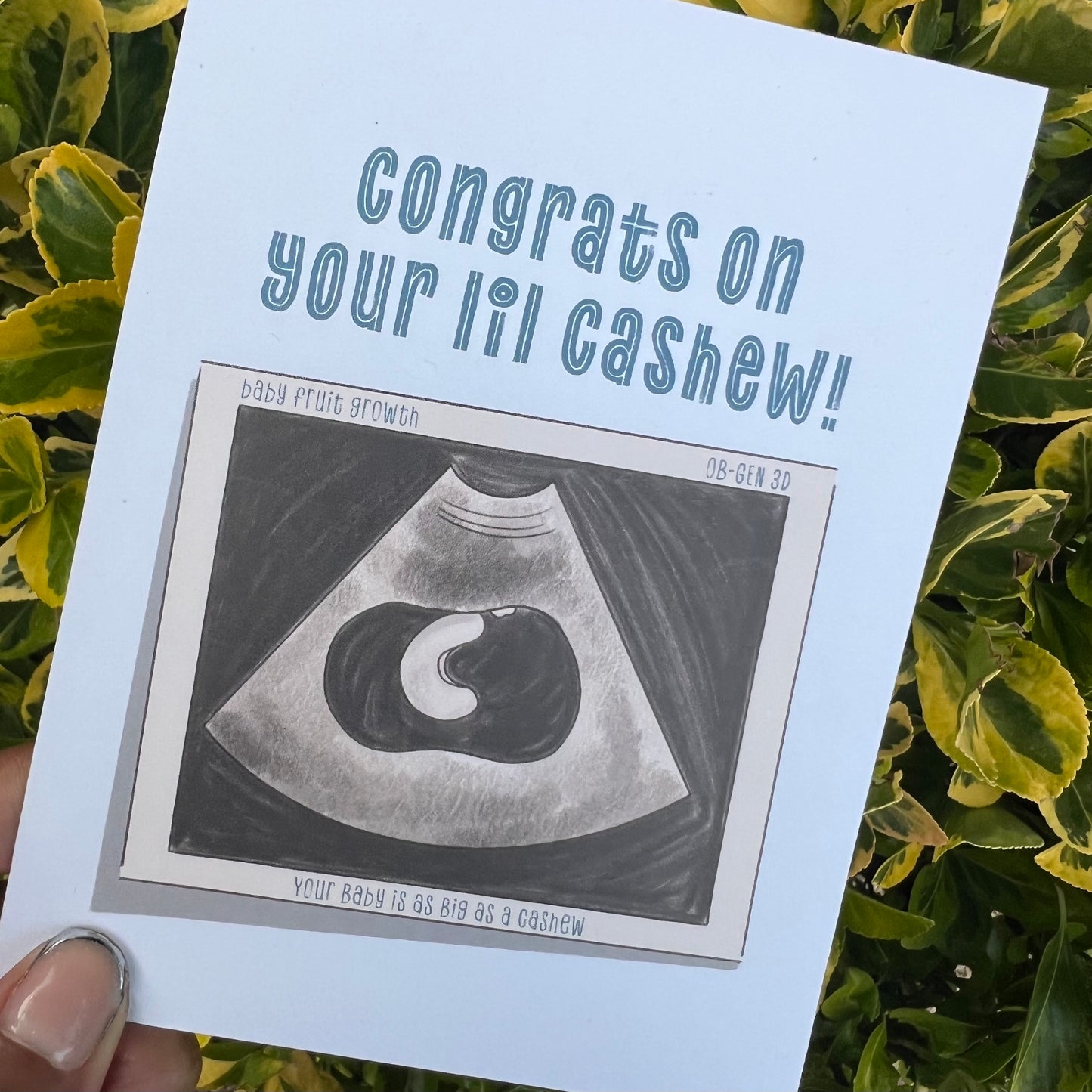 4.25 x 5.5” A2 size card illustration of a baby sonogram with a baby the size of a cashew. The card reads ‘Congrats on your lil cashew!’. Envelope included. Black Woman Owned.