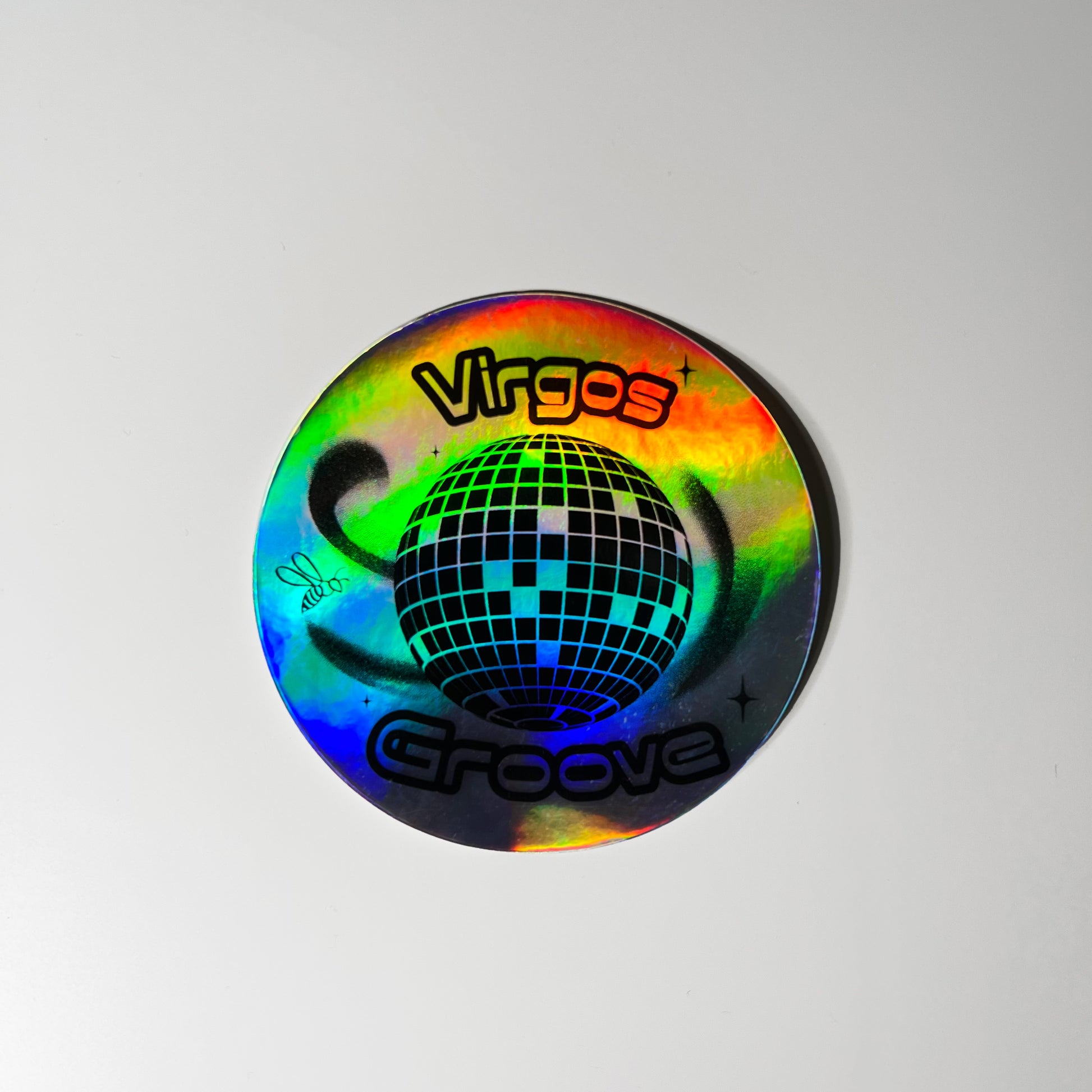 3 x 3” holographic waterproof sticker with a disco ball and the words ‘Virgo’s Groove’. A bee floats around the disco ball symbolizing Beyoncé’s bey-hive.High quality vinyl waterproof and scratch resistant sticker from Goods Made By Digitrillnana. Perfect for laptops, water bottles, phone cases, luggage, journals, and more! Black Woman Owned.
