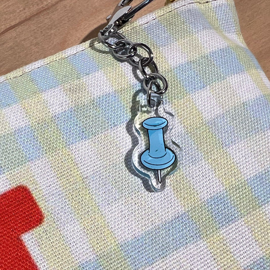 1” double-sided clear acrylic push pin keychain in textured baby blue with silver U-shaped hook clasp. Aesthetic bag charm for tote bags, backpacks, and crossbody bags. Perfect gift for stationery lovers.