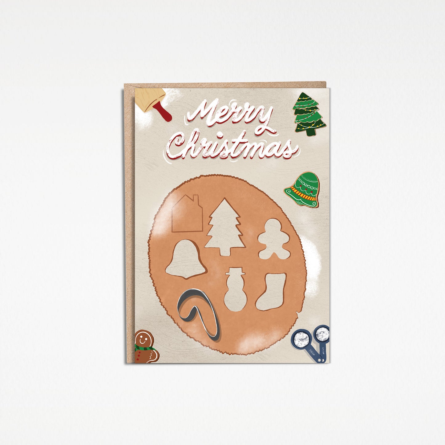 High quality 5x7 inch greeting card illustration of rolled out cookie dough with Christmas cookie cutters, three freshly baked cookies, a rolling pin, and two measuring cups full of flour on a kitchen countertop. The three baked cookies include a green christmas tree cookie, a gingerbread man cookie, and a green, red, white, and yellow holiday bell cookie. “Merry Christmas” is illustrated in a script font in white to imitate flour. Available as a single card or a set of 8 cards.