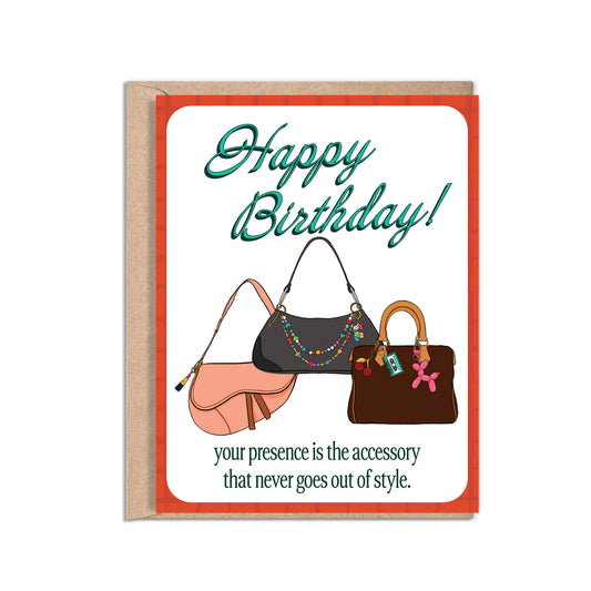 4.25 x 5.5” A2 illustration of dior saddle bag, and two shoulder bags with colorful bag charms. “Happy Birthday!" text in turquoise and “your presence is the accessory that never goes out of style.” at the bottom. Blank inside. Envelope included. 