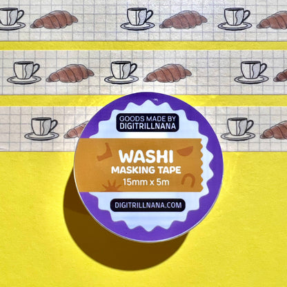 15mm sem-transparent washi tape roll featuring a illustrated coffee cup and saucer and croissant on a light blue grid background. re-adjustable and removable. Perfect for your planner, junk journal, and scrapbook.