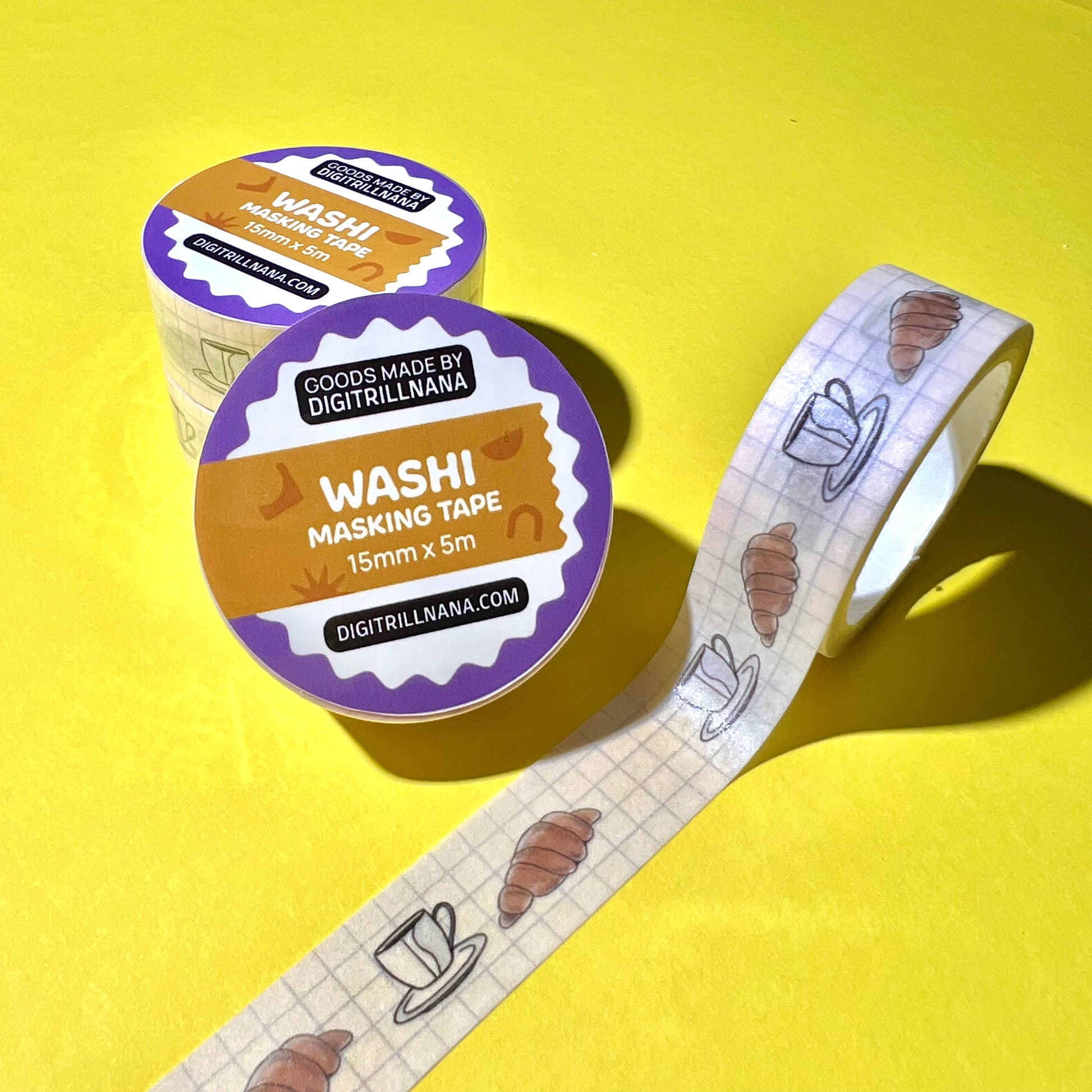 15mm sem-transparent washi tape roll featuring a illustrated coffee cup and saucer and croissant on a light blue grid background. re-adjustable and removable. Perfect for your planner, junk journal, and scrapbook.