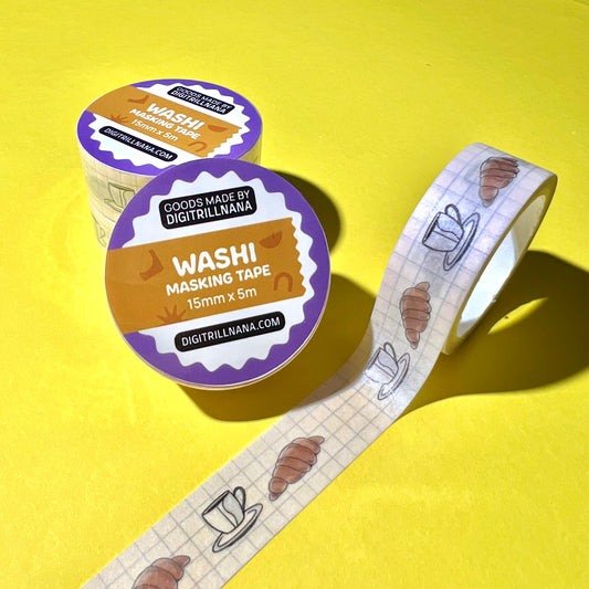 15mm sem-transparent washi tape roll featuring a illustrated coffee cup and saucer and croissant on a light blue grid background. re-adjustable and removable. Perfect for your planner, junk journal, and scrapbook.