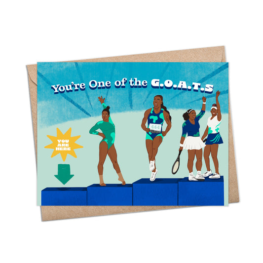 A2 sized card (5.5 x 4.25”) features illustrations of athletes Gabby Douglas, Sha’Carri Richardson, Venus, and Serena Williams on blue podiums. Each wears sports attire, posing uniquely. Text reads 'You’re One of the G.O.A.T.s'. A teal arrow with 'You Are Here' points to an empty podium. Blank inside. Envelope included.