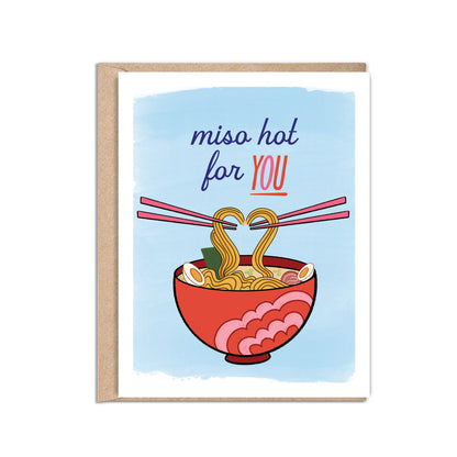 4.25 x 5.5” A2 size card illustration of a red and pink ramen bowl with scallions, seaweed, egg, and noodles. Two sets of pink chopsticks hold the noodles, creating the shape of a heart. The text reads, "Miso Hot For You". Blank inside. Black Woman Owned.