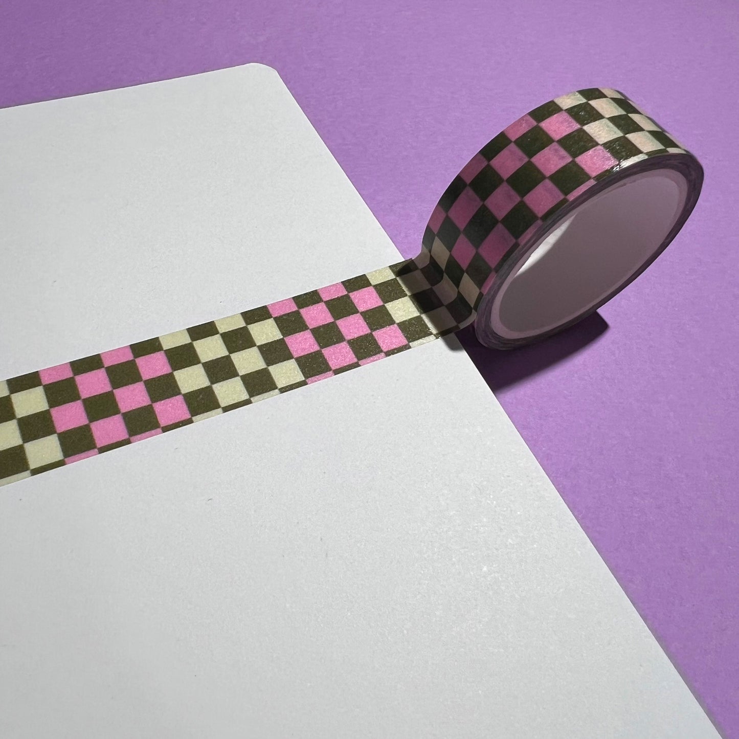 15mm checkered washi tape roll with a bold pink and green geometric pattern. Re-adjustable and removable. Perfect for your planner, junk journal, and scrapbook.