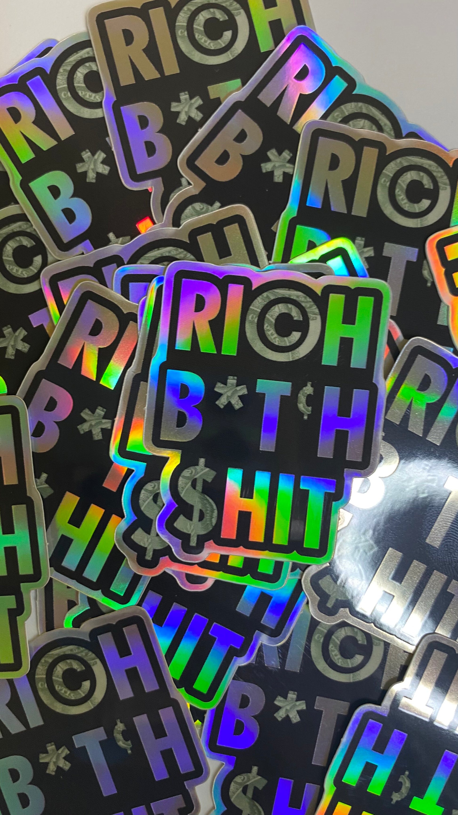 Rich B*tch Sh*t holographic high quality vinyl waterproof and scratch resistant sticker from Goods Made By Digitrillnana. Perfect for laptops, water bottles, phone cases, luggage, journals, and more! Black Woman Owned.