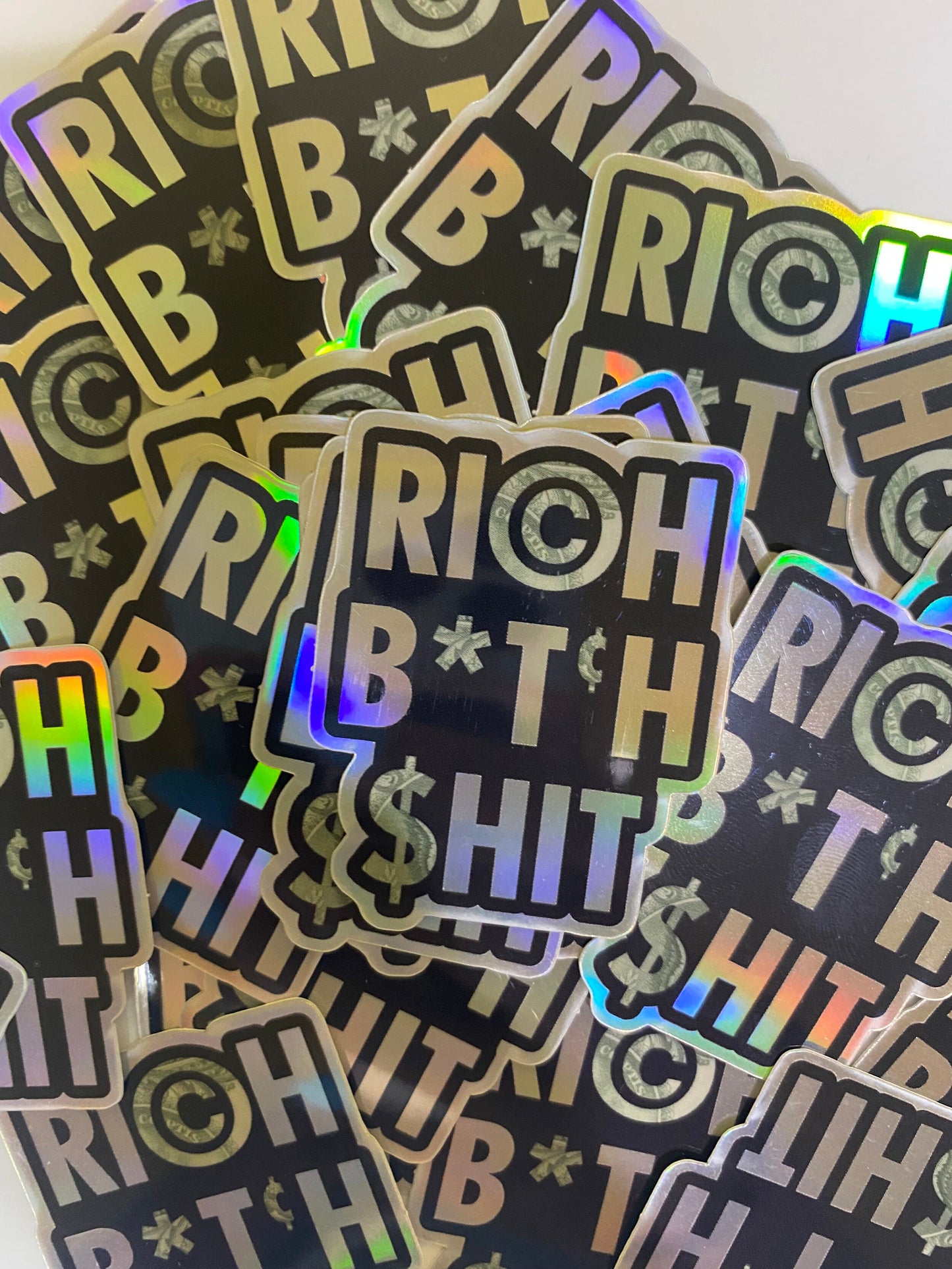 Rich B*tch Sh*t holographic high quality vinyl waterproof and scratch resistant sticker from Goods Made By Digitrillnana. Perfect for laptops, water bottles, phone cases, luggage, journals, and more! Black Woman Owned.
